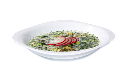 Summer yoghurt cold soup with radish, cucumber, and dill on white background. Okroshka