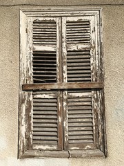 Old broken window on an abandoned old building Cyprus.  Dirty frame glass
