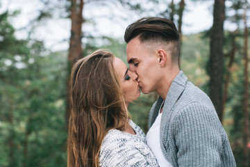 Beautiful youth couple flirting and joking in outdoor.