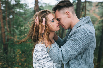 Beautiful youth couple flirting and joking in outdoor.