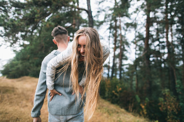 Beautiful youth couple flirting and joking in outdoor.