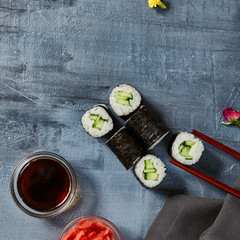 Cappamaki Sushi Roll with Soy Sauce and Ginger over Stone Background
