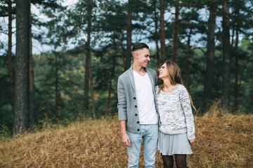 Beautiful youth couple flirting and joking in outdoor.