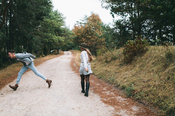 Fototapeta premium Beautiful youth couple flirting and joking in outdoor.