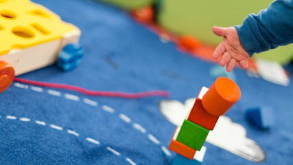 Cute and happy baby playing with his toys