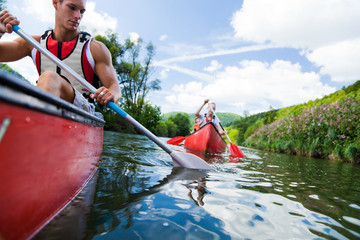 Young People Canoeing - obrazy, fototapety, plakaty