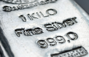 The surface of cast silver bullion. The texture of the surface of the silver bar. Selective focus.  (shallow DOF)