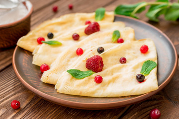 Pancakes with fresh berries and mint