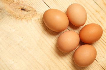Eggs lay on wooden background. Food ingredient.