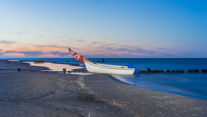 Fischerboot am Strand von Bansin im Sonnenuntergang
