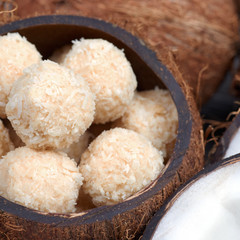 Homemade sweets in a coconut bowl. Toffee and coconut balls