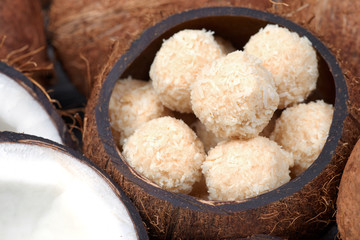 Homemade sweets in a coconut bowl. Toffee and coconut balls