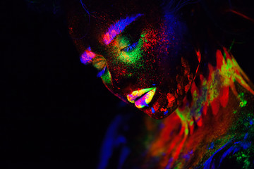 Beautiful extraterrestrial model woman in neon light. It is portrait of beautiful model with...