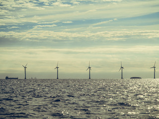 Wind turbines power generator farm along coast sea