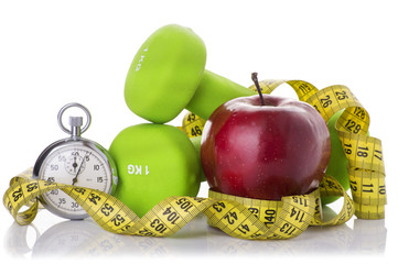 Two dumbbells, red apple, measuring tape.