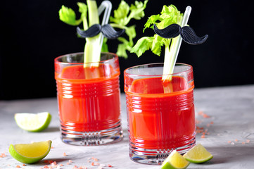 Traditional Bloody Mary cocktail with celery stick, lime and pink salt.  