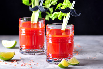 Traditional Bloody Mary cocktail with celery stick, lime and pink salt.  