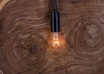 Old luminous light bulb on a dark background