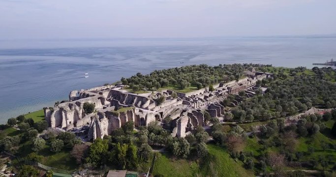 Wonderful aerial view of the Catullo caves in Sirmione. Video shot with the drone at 4K. The Caves are considered the largest archaeological zone of northern Italy.