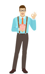 Businessman holding piggy bank and showing a okay hand sign