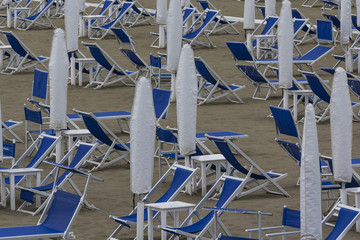 Tidy white and blue structure on a deserted beach. Marina di Pietrasanta, Italy