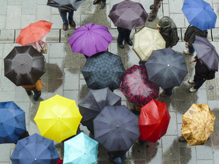 Bird's eye view of a group of people with umbrellas
