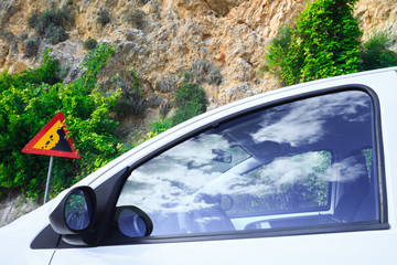 Contextual image concept: insurance - auto, property and life. Road sign falling stones, Traffic...