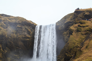 Skógafoss waterfall in southern Iceland on a cloudy winter day. 