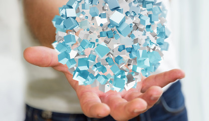 Businessman holding flying abstract sphere with shiny cube 3D rendering