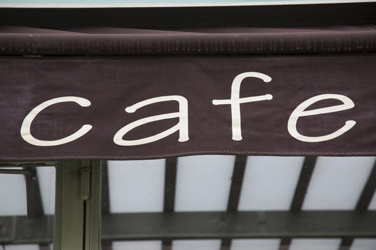 Cafe Sign on Building Facade