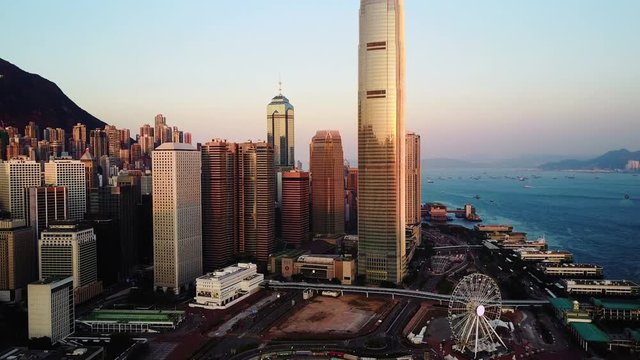 AERIAL. Top view of buildings in Hong Kong city at sunset.