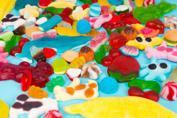 Fototapeta na wymiar Close up of cattered tasty bright chewing sweets and jelly candies