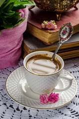 Beautiful still life in vintage style with coffee Cup and books.