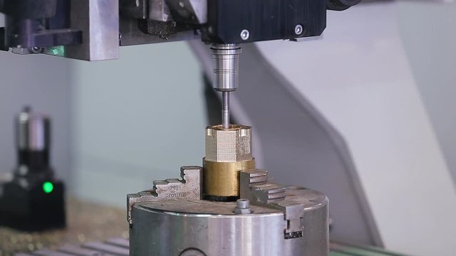 High precision CNC machining center 5 axis working, operator machining automotive sample part process in factory