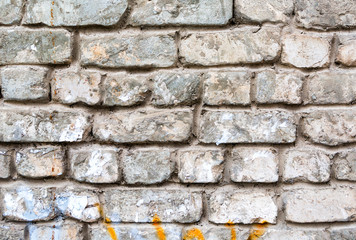Old weathered white brick wall as background