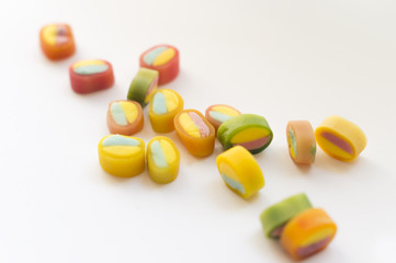 Coloured candies on white background