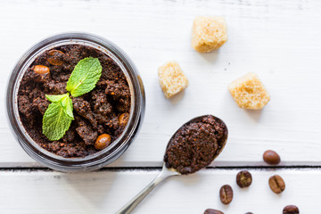 Organic scrub from ground coffee on table background top view