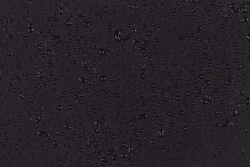 Water drops on dark stone
