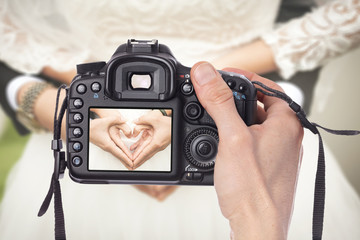 Professional Wedding Photographer taking pictures of bride and groom - obrazy, fototapety, plakaty
