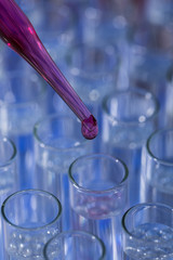 Pipette dropping fluid into test tube