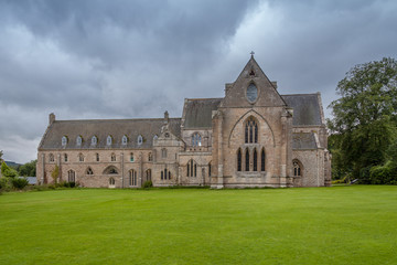 Pluscarden Abbey in Scotland with green grass and trees