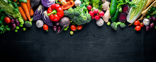 Big set organic food. Fresh raw vegetables. On a black chalkboard. - obrazy, fototapety, plakaty