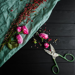 Rose and scissors on a black background