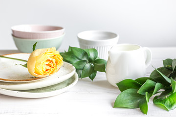 ceramic tableware with flowers on white background