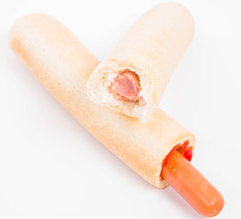 Hot dogs on a white background, one bitten