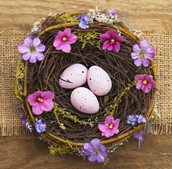 Easter eggs in nest on wooden table. Spring 