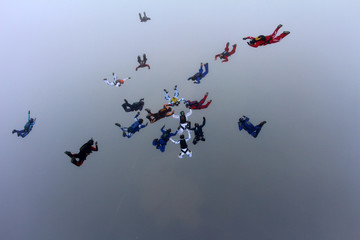 Skydivers make a formation in the sky.