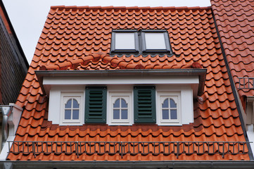 Tiled mansard roof of medieval building in Bremen, Germany.