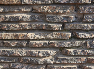 Detail of a wall of thin granite slabs. Texture, background