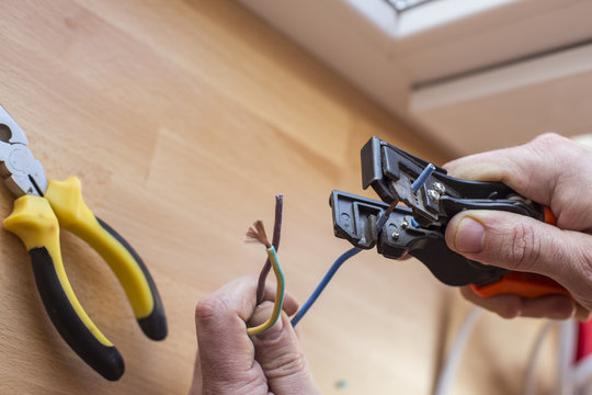 Electrician cuts the wire with special tools to connect